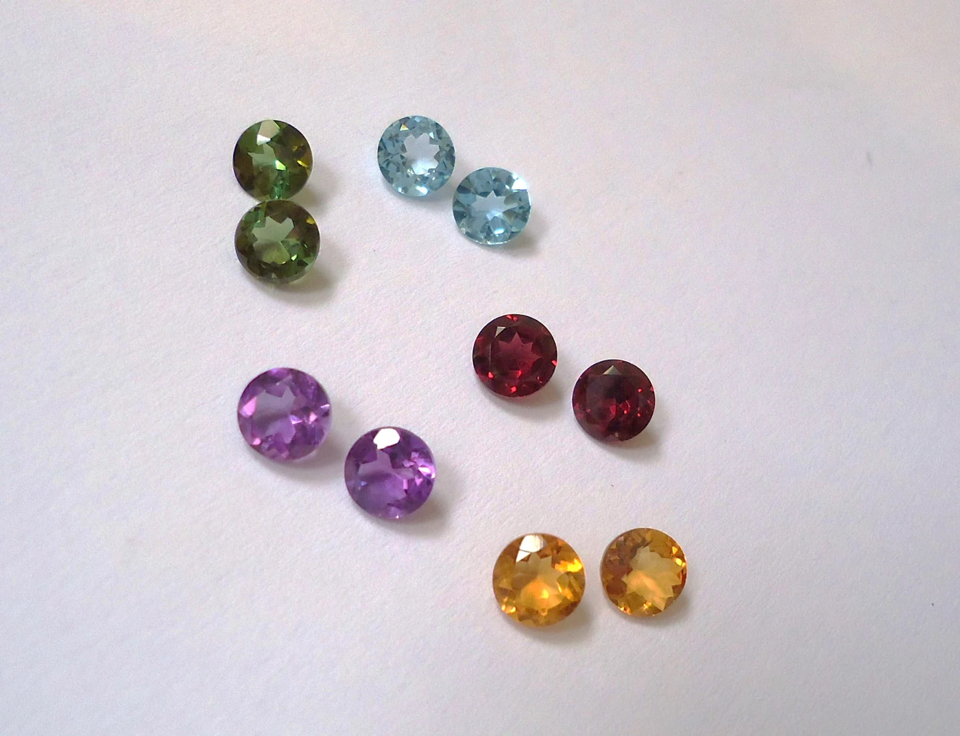 Pairs of green tourmalines, blue topazes, purple amethysts, red garnets plus yellow citrines
