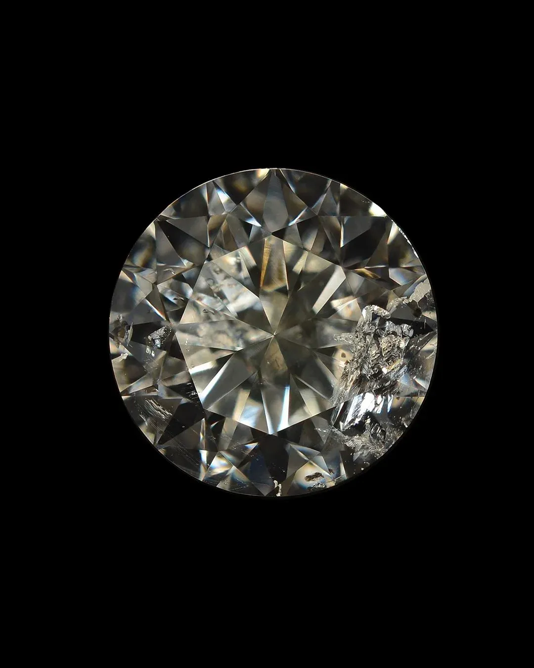 Round brilliant diamond with visible large inclusion, used to demonstrate clarity grading factors.