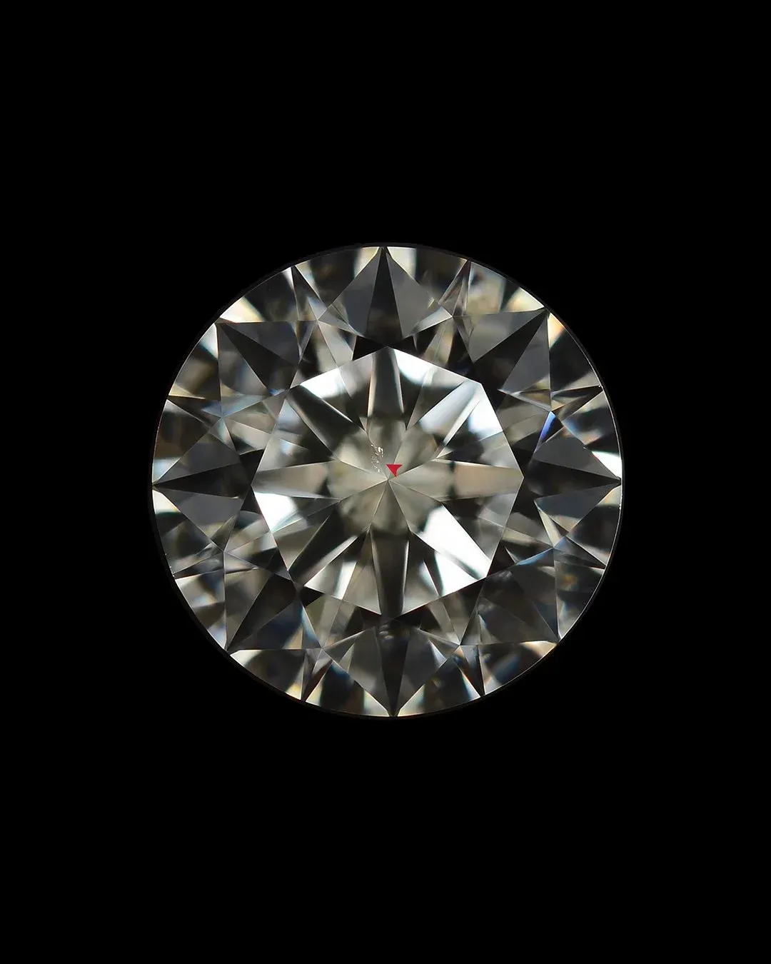 Round diamond with small visible inclusions, representing everyday clarity grades like VS, SI, and I.