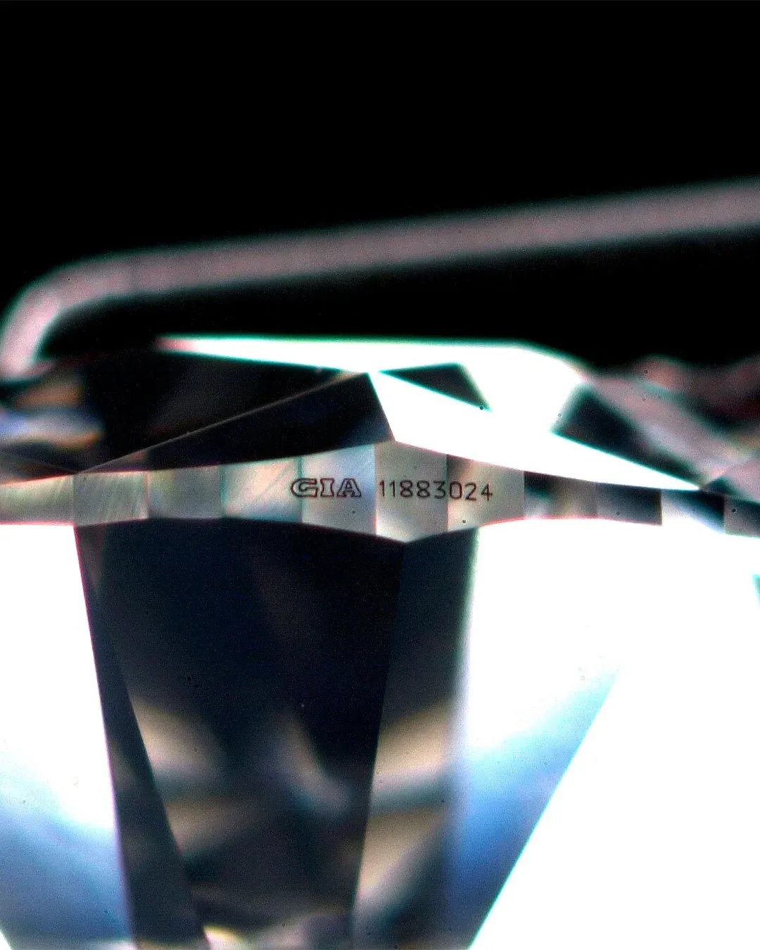 Close-up image of a diamond's laser inscription showing a GIA certification number on the girdle, highlighting the importance of certified diamonds for authenticity and traceability.